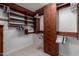 Well-organized walk-in closet with custom wood shelving and ample hanging space at 7175 E Camelback Rd # 1106, Scottsdale, AZ 85251