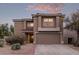 Two-story home showcasing desert landscaping, a tile roof, and a neutral stucco exterior with a two car garage at 7500 E Deer Valley Rd # 157, Scottsdale, AZ 85255