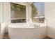 Close-up of bathroom tub surrounded by windows at 7810 W Wescott Dr, Glendale, AZ 85308