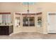 Bright dining area with pool views, a decorative chandelier, and tile flooring at 7810 W Wescott Dr, Glendale, AZ 85308