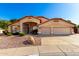 Charming single-story home with well-maintained landscaping, desert rock yard, and a two-car garage at 7810 W Wescott Dr, Glendale, AZ 85308