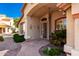 Welcoming front entrance featuring decorative shrubs and a patterned security door with a stone pathway at 7810 W Wescott Dr, Glendale, AZ 85308