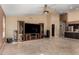 Expansive living area with a ceiling fan, tile floors, and an entertainment center at 7810 W Wescott Dr, Glendale, AZ 85308