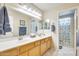 Well-lit bathroom with a double sink vanity and a separate room for the toilet and shower at 9174 W Marconi Ave, Peoria, AZ 85382