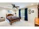 Cozy bedroom featuring a dark wood bed frame, carpet, and a ceiling fan at 9174 W Marconi Ave, Peoria, AZ 85382