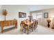 Charming dining room with a wooden table set for six, bathed in natural light from a nearby window at 9174 W Marconi Ave, Peoria, AZ 85382