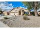 Charming single-story home with a three-car garage and desert landscaping under a sunny, partly cloudy sky at 9174 W Marconi Ave, Peoria, AZ 85382