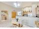 Bright kitchen area with tile flooring, light wood cabinets, and a breakfast nook at 9174 W Marconi Ave, Peoria, AZ 85382