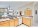 Bright kitchen featuring a breakfast bar with ample countertop space, flowing into the open-concept living area at 9174 W Marconi Ave, Peoria, AZ 85382