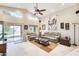 Comfortable living room with neutral colors, ceiling fan, and sliding glass doors to the outside at 9174 W Marconi Ave, Peoria, AZ 85382