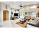 Bright living room with tall ceilings, neutral carpet, ceiling fan, and sliding doors at 9174 W Marconi Ave, Peoria, AZ 85382