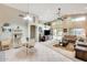 Spacious living room featuring high ceilings, a ceiling fan, and access to the backyard at 9174 W Marconi Ave, Peoria, AZ 85382