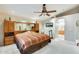 Large bedroom featuring a ceiling fan, carpet, and an attached bath through an archway at 9174 W Marconi Ave, Peoria, AZ 85382