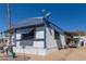 Exterior side view of home with awning, golf cart, gravel yard, and a satellite dish at 9501 E Broadway Rd # 241, Mesa, AZ 85208