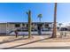 Charming single-story home featuring a covered porch, desert landscaping, and a sunny blue sky at 9501 E Broadway Rd # 241, Mesa, AZ 85208