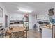 Well-lit kitchen featuring white cabinetry, stainless steel appliances, and an adjacent dining area at 9501 E Broadway Rd # 241, Mesa, AZ 85208