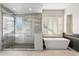 Modern bathroom with a glass-enclosed shower, soaking tub, and neutral tile at 9776 E Granite Peak Trl, Scottsdale, AZ 85262