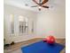 Bright exercise room with wood floors, natural light, and workout equipment at 9776 E Granite Peak Trl, Scottsdale, AZ 85262