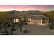 Charming desert home with a three-car garage and a beautiful landscape at sunset at 9776 E Granite Peak Trl, Scottsdale, AZ 85262