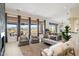 Bright living room with desert views, neutral furniture, and elegant curtains at 9776 E Granite Peak Trl, Scottsdale, AZ 85262