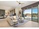 Bright living room featuring neutral tones, fireplace, and sliding doors to the outdoor pool area at 9776 E Granite Peak Trl, Scottsdale, AZ 85262