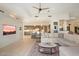 Open-concept living room with modern finishes, adjacent to the kitchen and featuring a large TV at 9776 E Granite Peak Trl, Scottsdale, AZ 85262