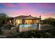 Back exterior view showcasing the home's covered patio, swimming pool, and desert landscaping at 9776 E Granite Peak Trl, Scottsdale, AZ 85262