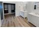 Bathroom featuring dual vanities, wood-look flooring, and a walk-in closet at 10320 W Cashman Dr, Peoria, AZ 85383