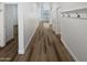 Hallway featuring wood floors, clean white walls, and coat hooks at 10320 W Cashman Dr, Peoria, AZ 85383