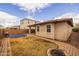 Backyard featuring a trampoline, fire pit, grassy lawn, and brick-paved patio, with a privacy fence at 10617 E Durant Dr, Mesa, AZ 85212