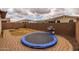 Backyard featuring a trampoline, barbecue grill, brick-paved patio, and a fire pit at 10617 E Durant Dr, Mesa, AZ 85212