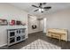 Open living space with neutral walls, ceiling fan, and wood-look floors, and a decorative area rug at 10617 E Durant Dr, Mesa, AZ 85212