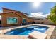 Backyard view of a sparkling swimming pool and patio space perfect for relaxation and entertainment at 10816 W Nosean Rd, Peoria, AZ 85383