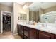 Bathroom with dual sinks, wood cabinets, and a separate shower area, providing both style and functionality at 10816 W Nosean Rd, Peoria, AZ 85383