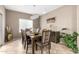 Dining room with elegant chandelier lighting, a large table with seating for eight, and decorative accents at 10816 W Nosean Rd, Peoria, AZ 85383