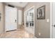 Inviting entryway with neutral walls, tiled floor, and white doors with access to other living spaces at 10816 W Nosean Rd, Peoria, AZ 85383