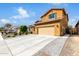 Charming two-story home featuring a terracotta roof, yellow stucco, and a two-car garage at 10816 W Nosean Rd, Peoria, AZ 85383