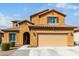 Charming two-story home featuring a terracotta roof, yellow stucco, and a two-car garage at 10816 W Nosean Rd, Peoria, AZ 85383