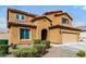 Charming two-story home featuring a terracotta roof, yellow stucco, and a two-car garage at 10816 W Nosean Rd, Peoria, AZ 85383