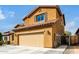 Charming two-story home featuring a terracotta roof, yellow stucco, and a two-car garage at 10816 W Nosean Rd, Peoria, AZ 85383