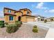 Charming two-story home featuring a terracotta roof, yellow stucco, and a two-car garage at 10816 W Nosean Rd, Peoria, AZ 85383