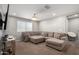 Cozy living room featuring a large grey sectional and lots of natural light at 10816 W Nosean Rd, Peoria, AZ 85383