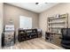 Cozy home office featuring neutral walls, wood-look flooring, window and ample storage at 10816 W Nosean Rd, Peoria, AZ 85383