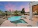 Backyard featuring pool with rock features, desert landscaping, and patio at 11322 N 118Th Way, Scottsdale, AZ 85259