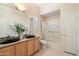 Bright bathroom featuring granite counters, dual sinks, and shower with gold trim at 11322 N 118Th Way, Scottsdale, AZ 85259