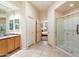 Bright bathroom featuring double doors, glass shower, and tiled floors and vanity at 11322 N 118Th Way, Scottsdale, AZ 85259