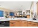 Bright kitchen area features an island, a breakfast bar, tile flooring, and black appliances at 11322 N 118Th Way, Scottsdale, AZ 85259