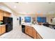 Kitchen features island, white countertops, tile flooring and black appliances at 11322 N 118Th Way, Scottsdale, AZ 85259