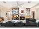 Open living room boasts fireplace, built-in shelving, and neutral tile flooring throughout at 11322 N 118Th Way, Scottsdale, AZ 85259