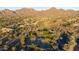 Breathtaking aerial of community tennis courts surrounded by lush desert landscape and homes at 11496 E Pine Valley Rd, Scottsdale, AZ 85255